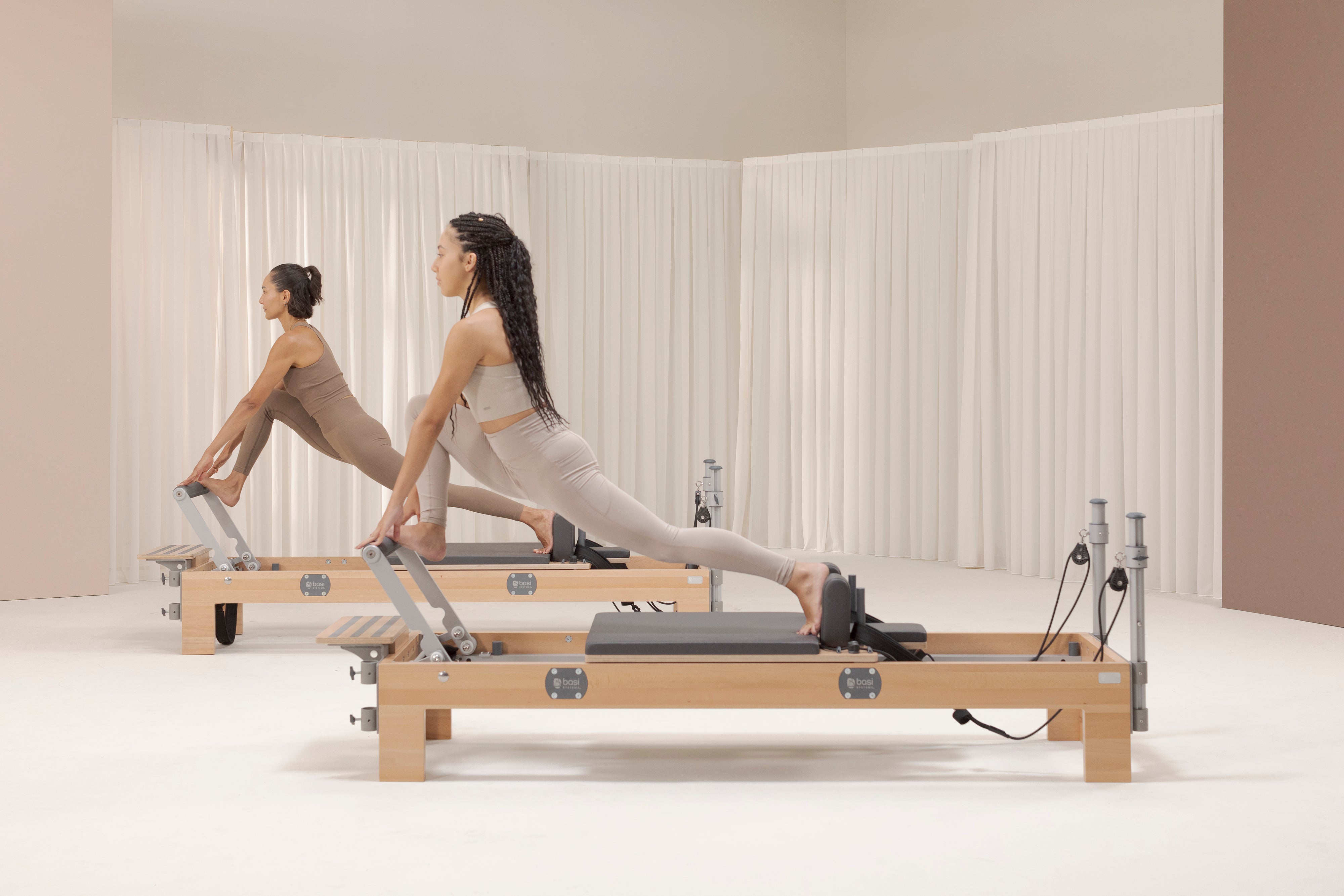 Women practicing Pilates on a BASI Systems compact reformer